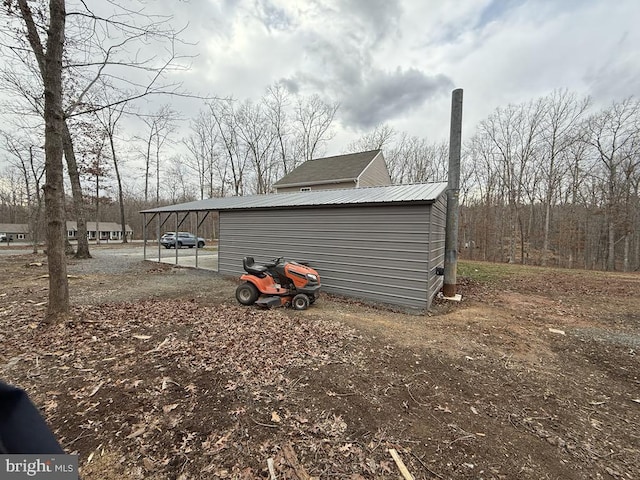 view of side of home with an outdoor structure and metal roof