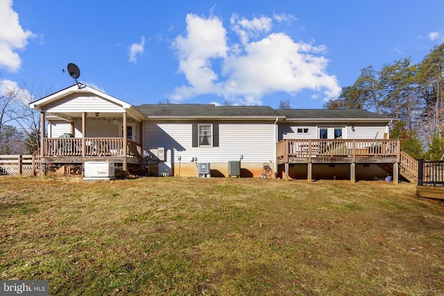 rear view of property featuring a wooden deck, a yard, and central air condition unit