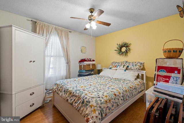 bedroom with hardwood / wood-style flooring and ceiling fan