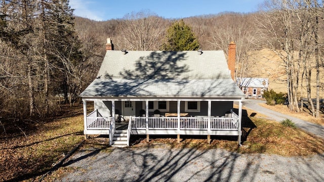 rear view of house featuring covered porch