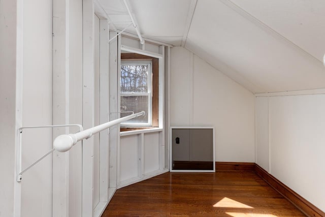 additional living space featuring lofted ceiling and dark wood-type flooring