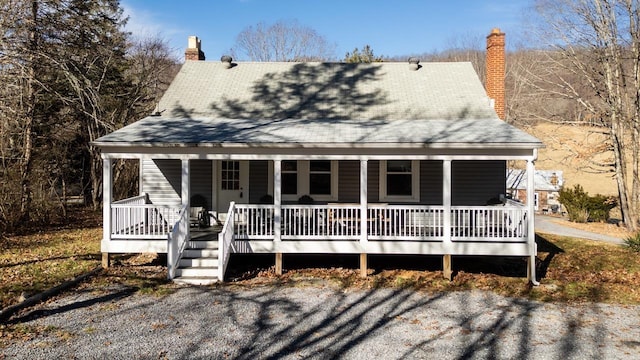 rear view of property with a porch