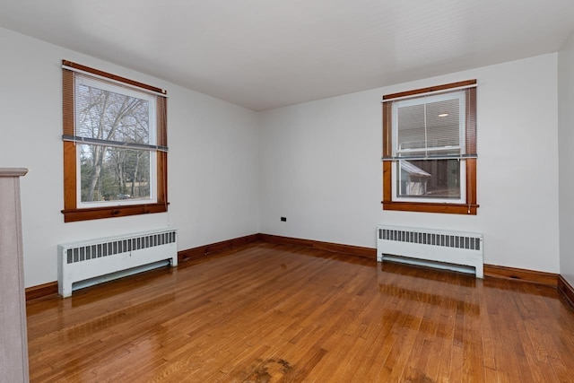 interior space with hardwood / wood-style flooring and radiator