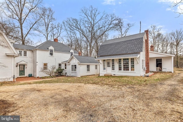 rear view of property featuring a yard