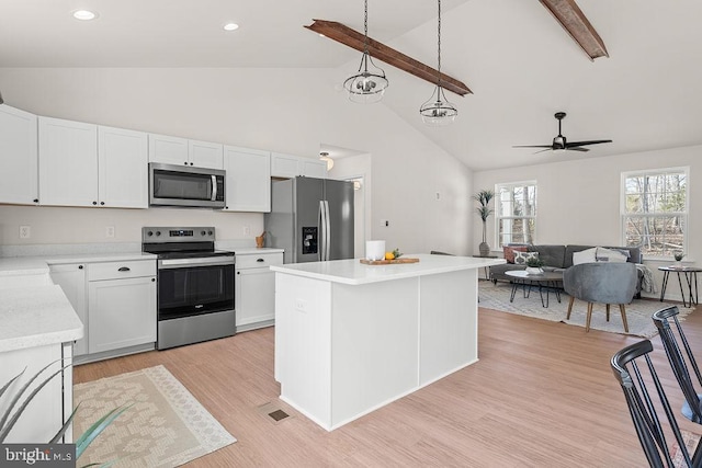 kitchen featuring stainless steel appliances, light wood-style floors, white cabinets, and light countertops