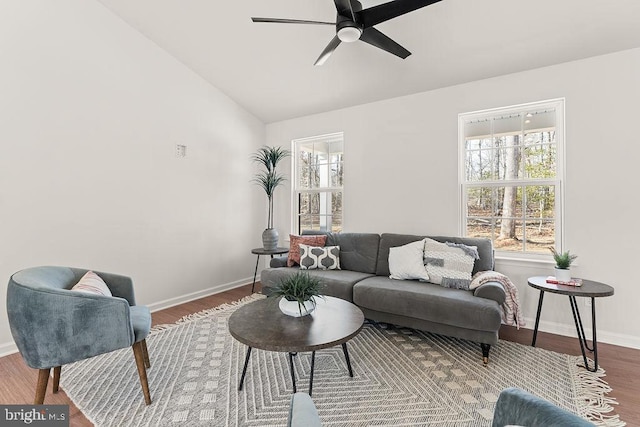 living area with lofted ceiling, wood finished floors, a ceiling fan, and baseboards