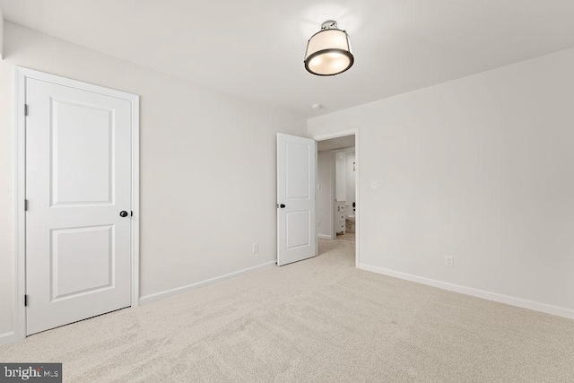 unfurnished bedroom featuring baseboards and carpet