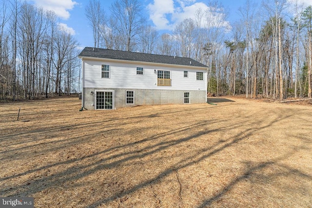 back of property featuring a lawn