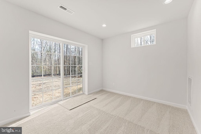 carpeted empty room with visible vents, recessed lighting, and baseboards