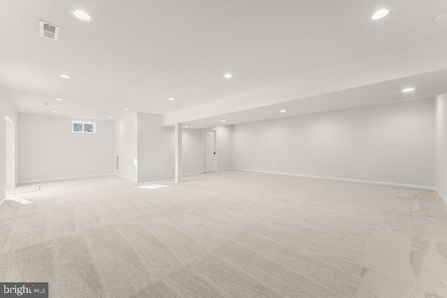 below grade area featuring visible vents, recessed lighting, and light colored carpet