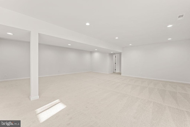 finished below grade area featuring recessed lighting, baseboards, light carpet, and visible vents