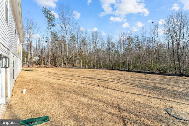 view of yard featuring a view of trees