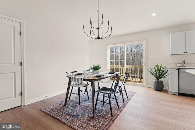 dining space featuring a chandelier, recessed lighting, light wood-style flooring, and baseboards