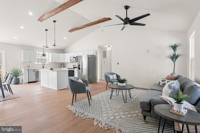 living area with ceiling fan, beamed ceiling, light wood-type flooring, recessed lighting, and high vaulted ceiling