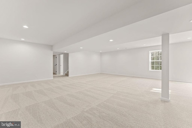 basement featuring light carpet, recessed lighting, and baseboards