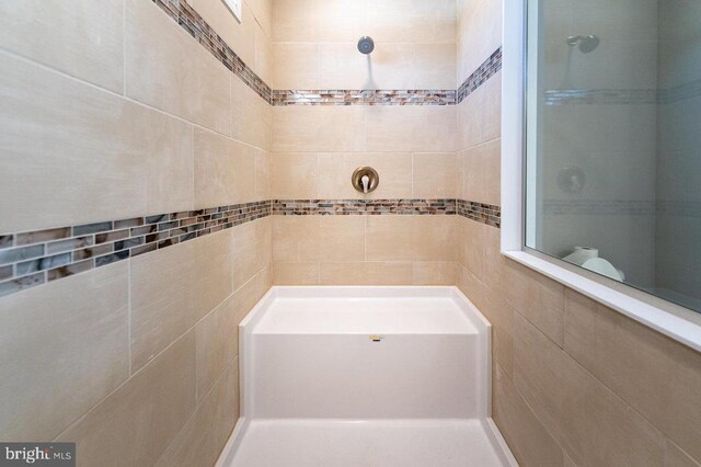 full bath featuring a tile shower