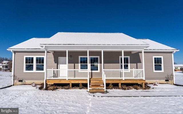 snow covered property with a porch and crawl space