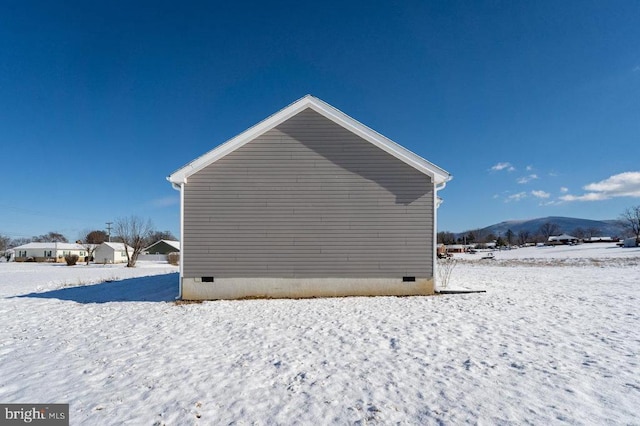 snow covered property with crawl space