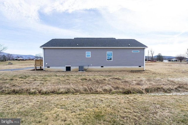 rear view of house featuring crawl space and central AC