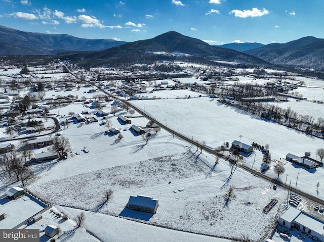 snowy aerial view featuring a mountain view