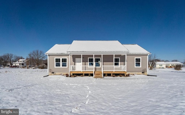 snow covered rear of property featuring crawl space and covered porch