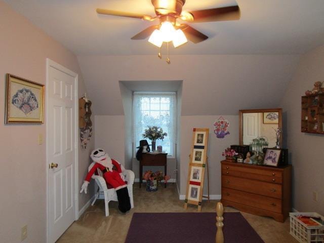 interior space featuring ceiling fan, baseboards, and vaulted ceiling