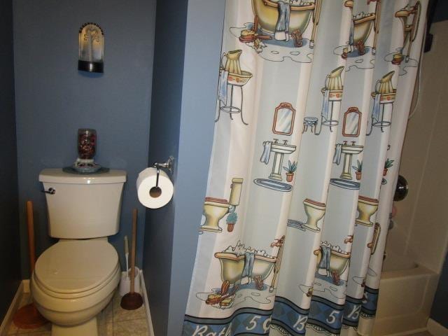 full bathroom with toilet and tile patterned flooring