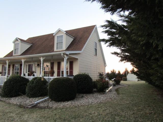 view of home's exterior featuring a porch and a lawn