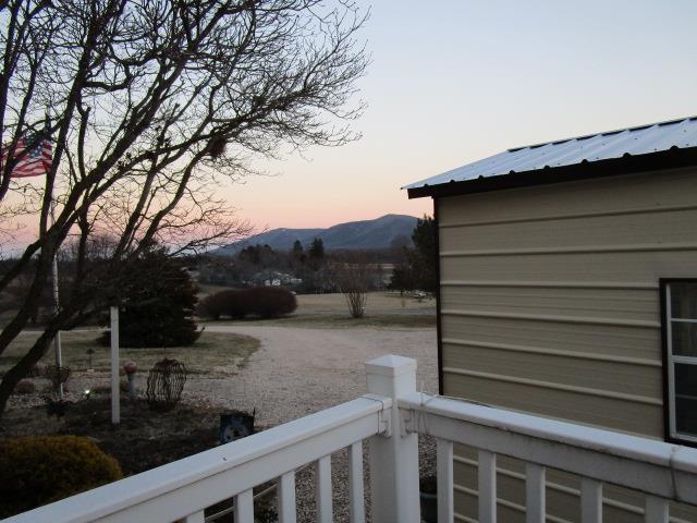 view of yard featuring a mountain view and a balcony