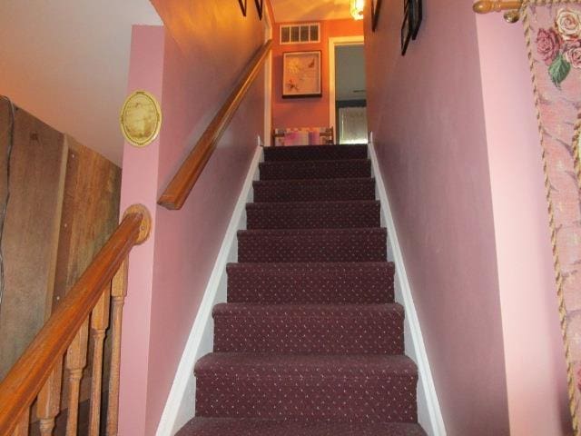 stairs featuring visible vents and baseboards