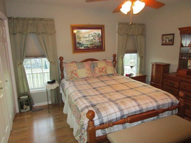 bedroom featuring ceiling fan and wood finished floors