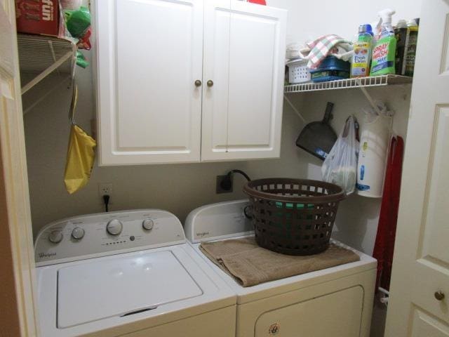 laundry area featuring cabinet space and washing machine and clothes dryer