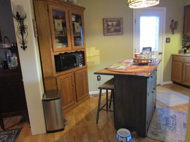 interior space featuring light wood finished floors and baseboards