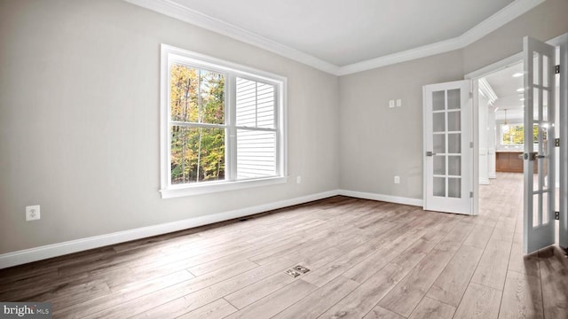 spare room with ornamental molding, light hardwood / wood-style flooring, and french doors