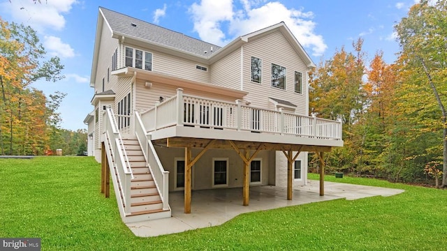 back of property featuring a wooden deck, a patio, and a lawn