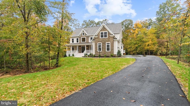 view of front of property with a front yard and covered porch