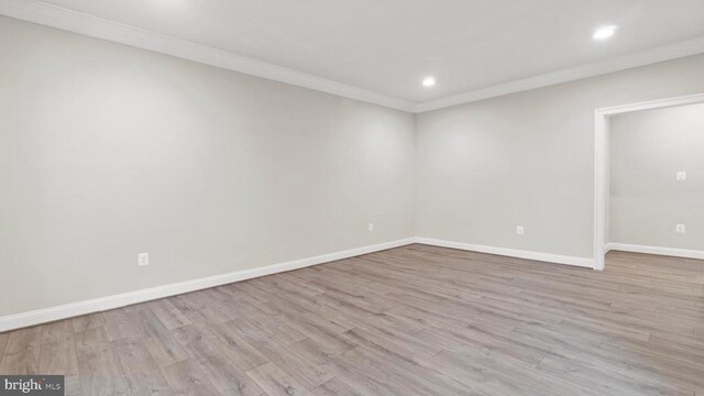 spare room with crown molding and light hardwood / wood-style floors