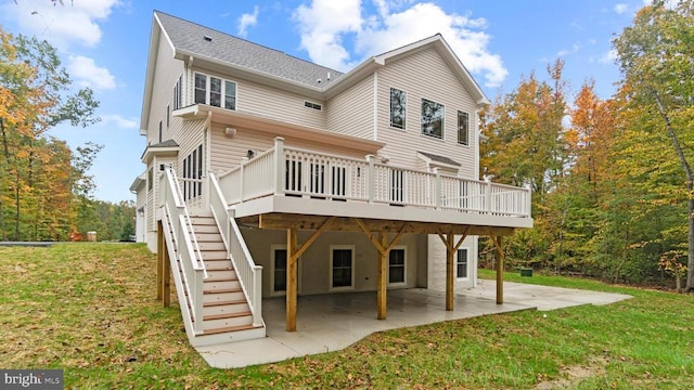 back of property with a wooden deck, a yard, and a patio area