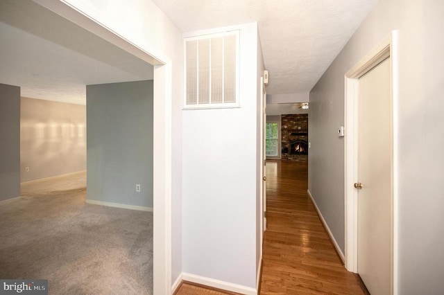 hall with hardwood / wood-style floors