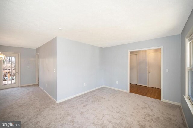 unfurnished room with visible vents, carpet flooring, and baseboards