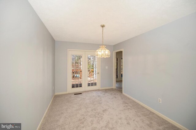 unfurnished dining area with carpet, baseboards, and visible vents