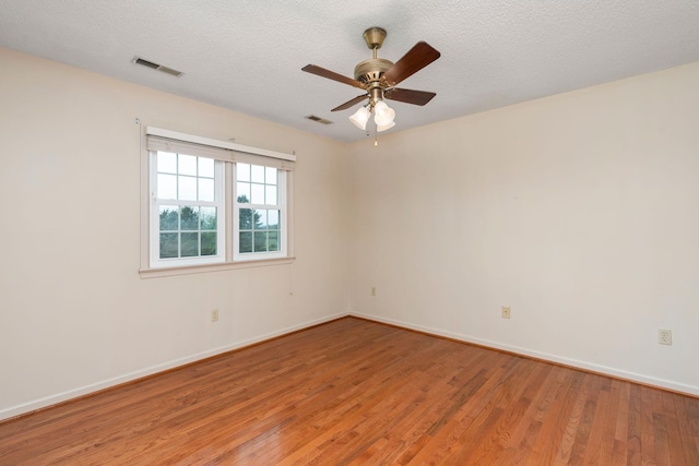 unfurnished room with baseboards, light wood-style floors, and visible vents