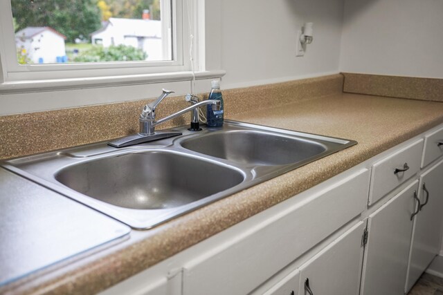 kitchen featuring sink and white cabinets