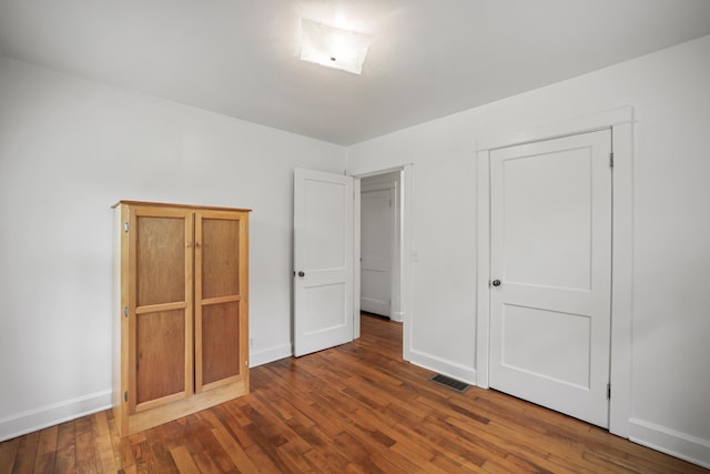 unfurnished bedroom featuring dark hardwood / wood-style floors