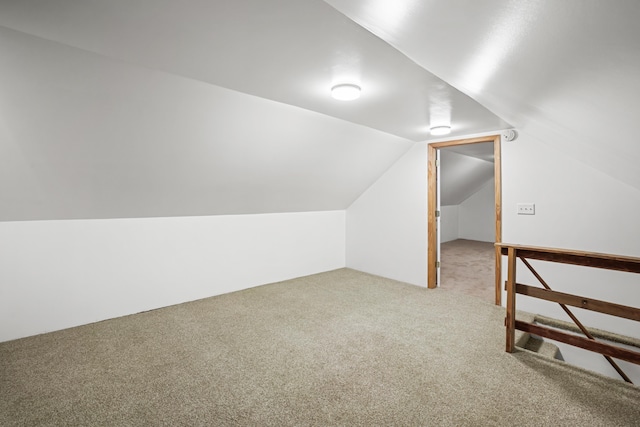 bonus room with lofted ceiling and carpet floors