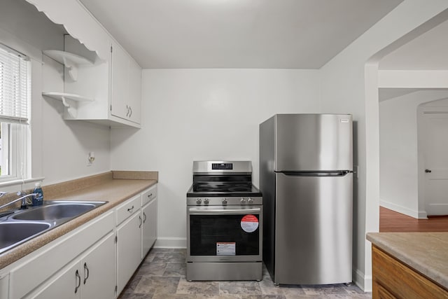 kitchen with white cabinetry, sink, and stainless steel appliances