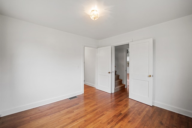 unfurnished room featuring wood-type flooring