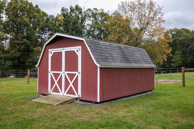 view of outdoor structure featuring a lawn