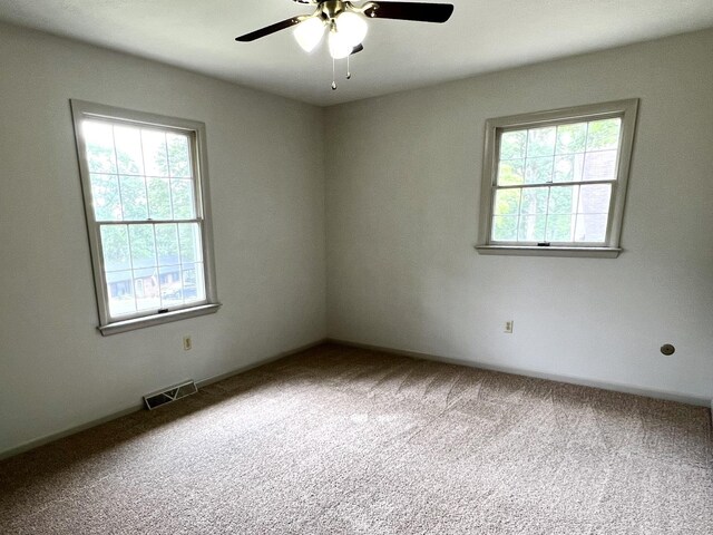 empty room featuring ceiling fan and carpet flooring