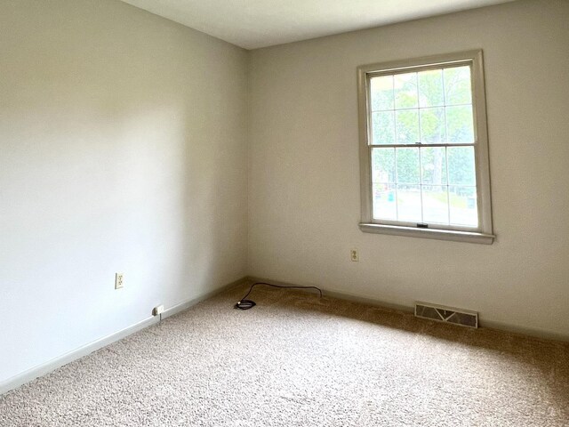 spare room featuring carpet flooring